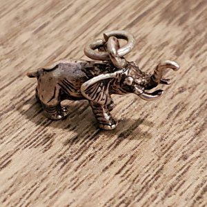 Petite trumpeting elephant charm pendant